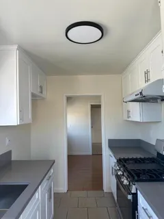 a kitchen with stainless steel appliances granite countertop a sink stove and cabinets