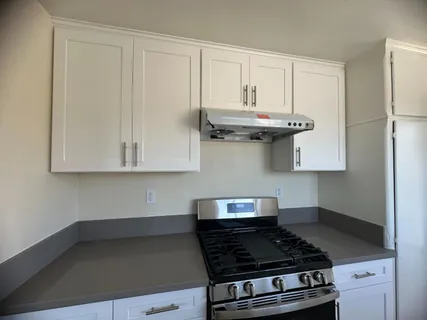 a kitchen with a sink a window and cabinets