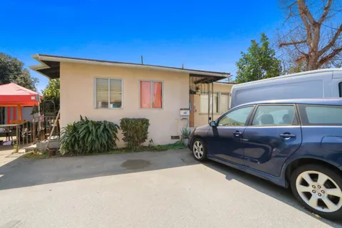 a view of a dining room with furniture and a chandelier