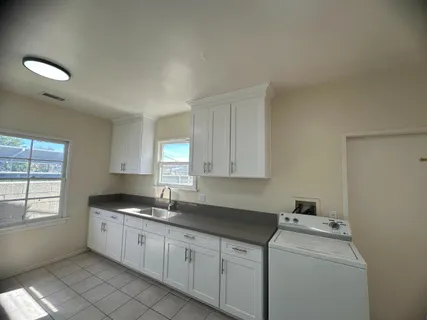 a kitchen with a refrigerator a stove top oven and a sink