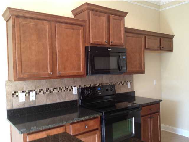 4619 Hermosa Road Crestview, FL 32539 - Photo 21 of 25 a kitchen with stainless steel appliances granite countertop a stove a sink and a microwave
