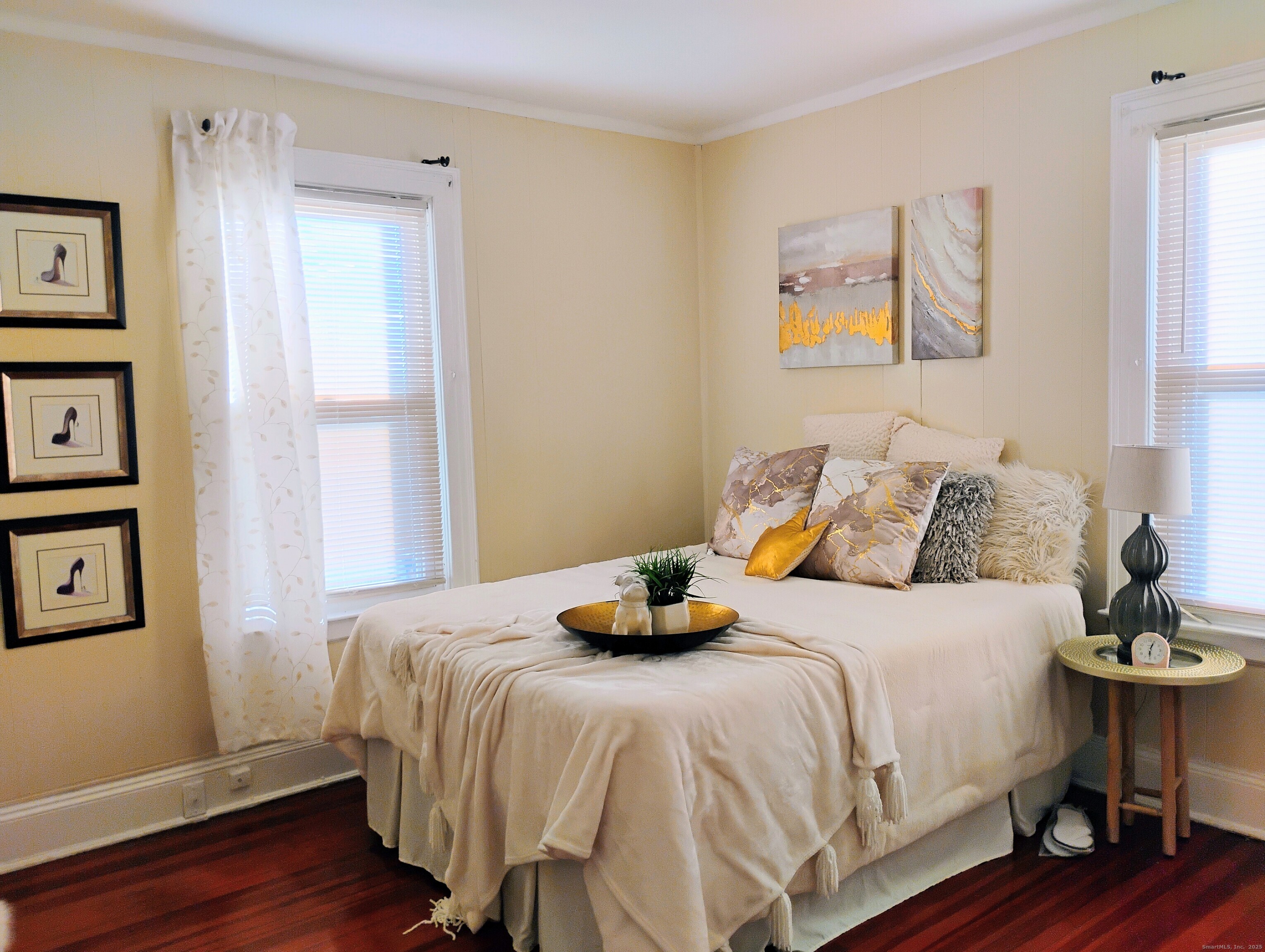 83 Colebrook Street Hartford, CT 06112 - Photo 12 of 36 a bedroom with a bed and wooden floor