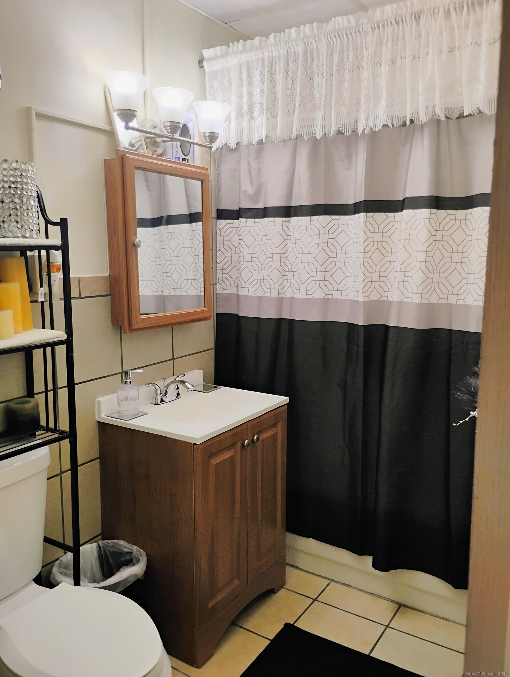 83 Colebrook Street Hartford, CT 06112 - Photo 32 of 36 a bathroom with a sink a toilet and a mirror