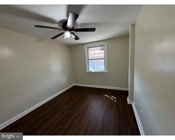a view of an empty room and wooden floor