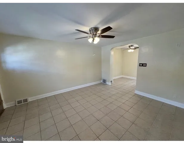 a view of a livingroom with a ceiling fan and window