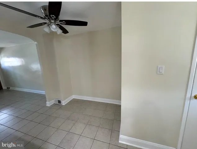 a view of an empty room with a fan