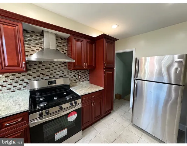 a kitchen with granite countertop a stove and a refrigerator