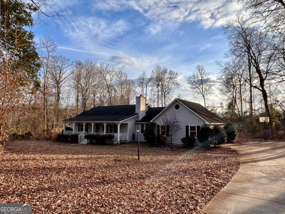 3968 South Apple Valley Road Commerce, GA 30529 - Photo 1 of 1 a front view of a house with a yard and balcony