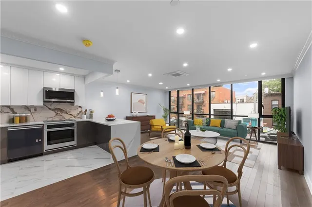 a large kitchen with a table and chairs