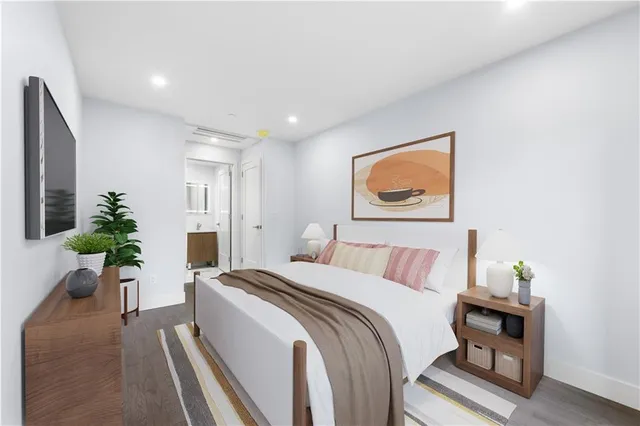 a bedroom with a bed and a painting on the wall