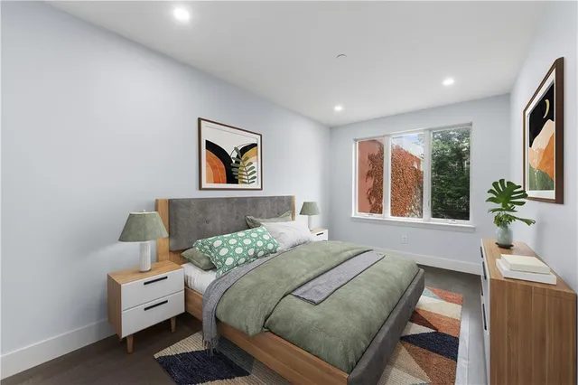 a bedroom with a bed and a large window