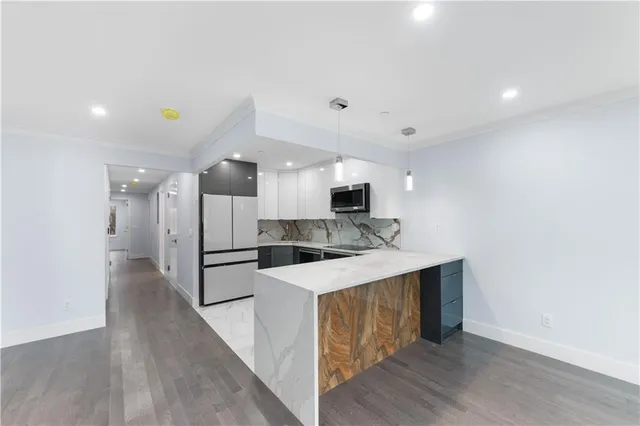 a kitchen with a sink a refrigerator and a microwave