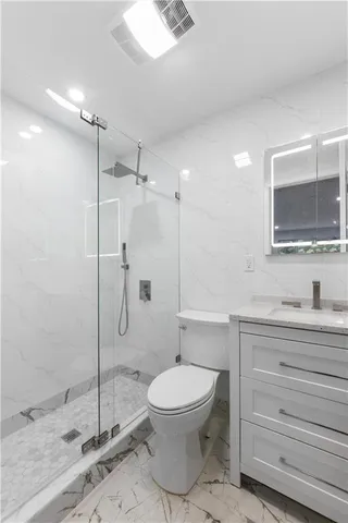 a bathroom with a toilet a sink and shower