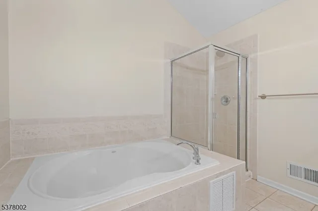 a bathroom with a tub and shower