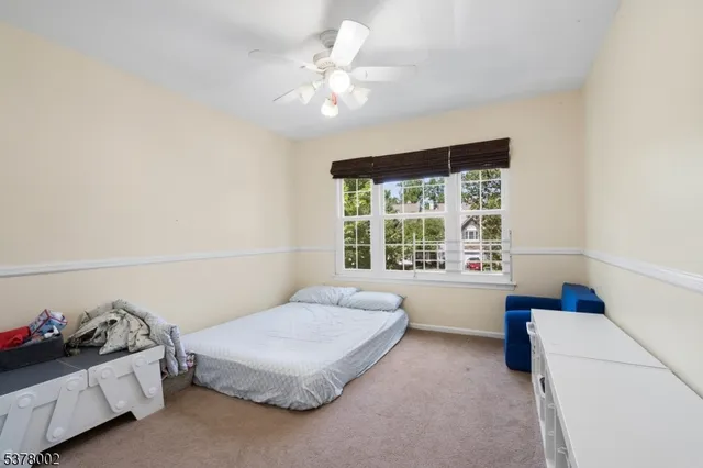 a spacious bedroom with a bed and a window