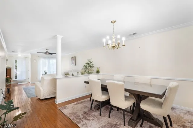 a view of a dining room with furniture and chandelier