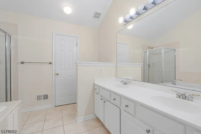 a spacious bathroom with a granite countertop sink a mirror and a