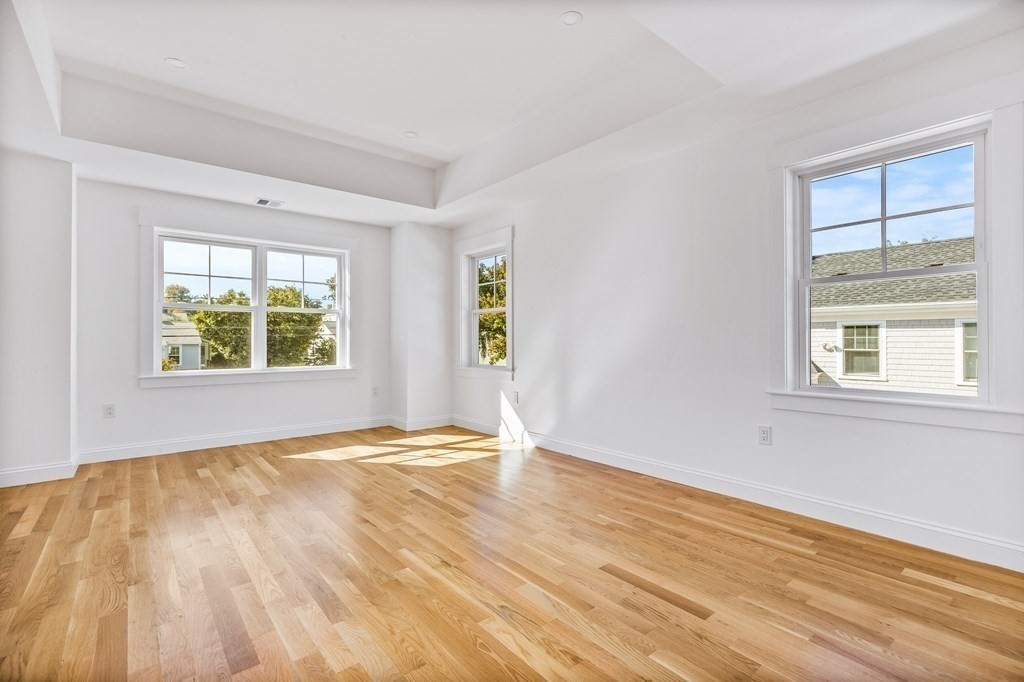 40 Foley Beach Road Hingham, MA 02043 - Photo 14 of 37 a view of an empty room with wooden floor and a window