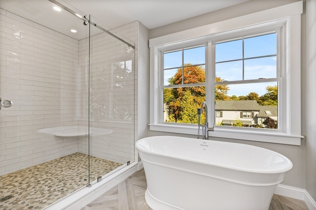 40 Foley Beach Road Hingham, MA 02043 - Photo 17 of 37 a bathroom with a granite countertop sink and a bathtub with shower
