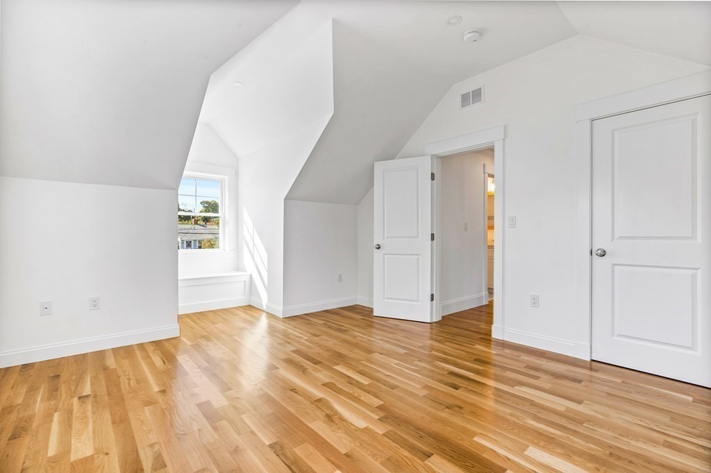 40 Foley Beach Road Hingham, MA 02043 - Photo 22 of 37 an empty room with wooden floor and windows