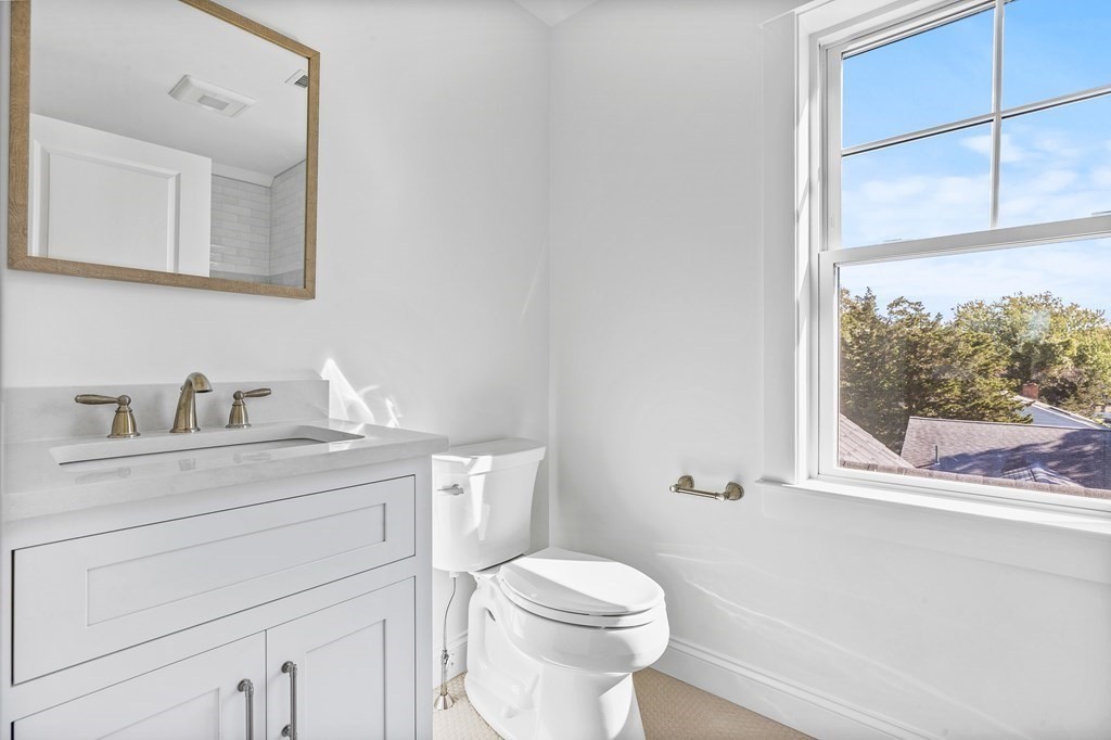 40 Foley Beach Road Hingham, MA 02043 - Photo 31 of 37 a bathroom with a toilet a sink a vanity and mirror