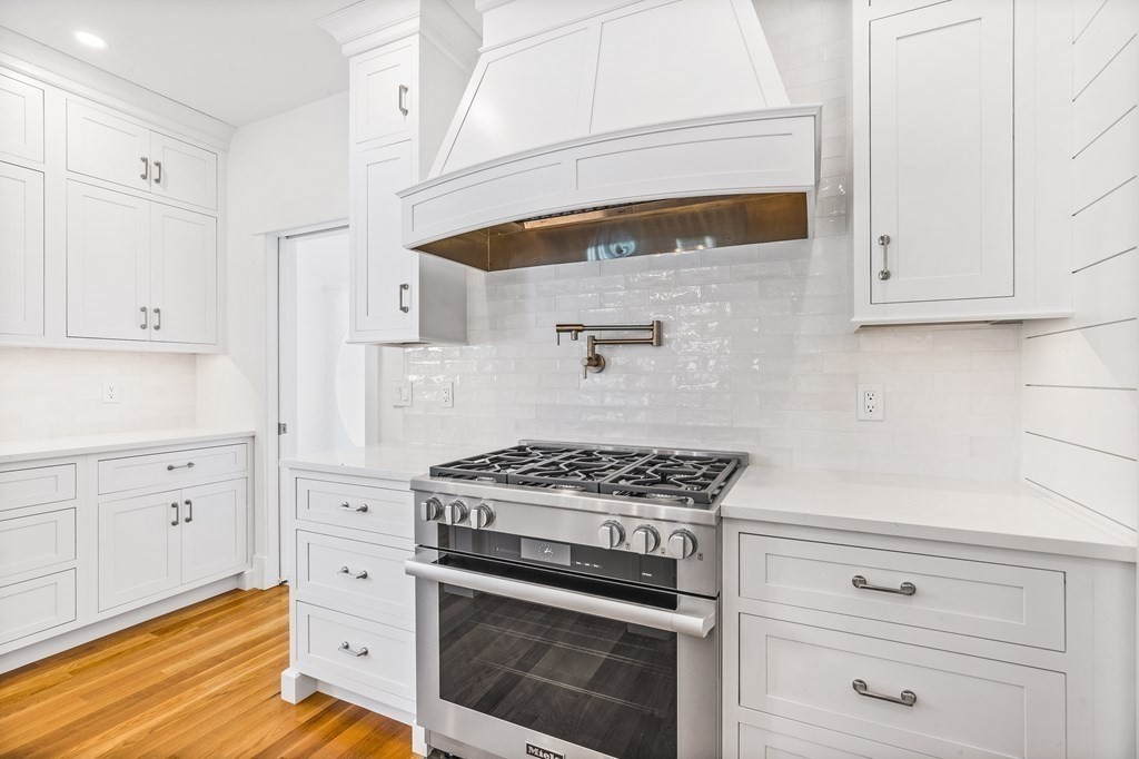 40 Foley Beach Road Hingham, MA 02043 - Photo 6 of 37 a kitchen with white cabinets and appliances