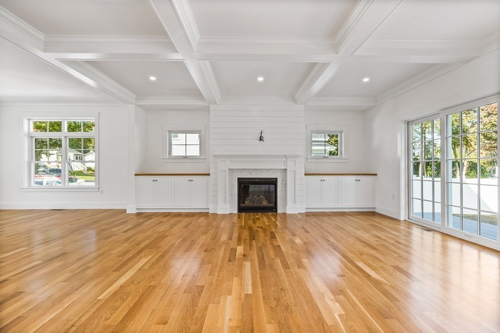 40 Foley Beach Road Hingham, MA 02043 - Photo 9 of 37 a view of empty room with wooden floor and fireplace
