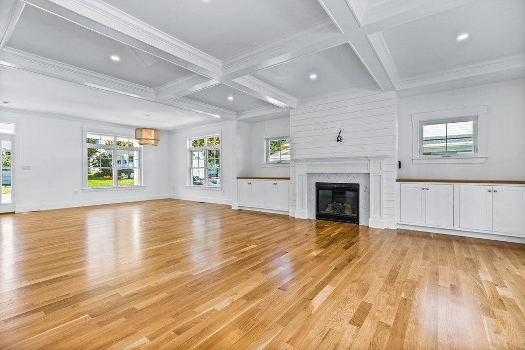 40 Foley Beach Road Hingham, MA 02043 - Photo 10 of 37 a view of empty room with wooden floor and fireplace