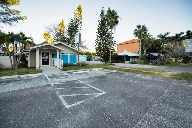 a front view of a house with a yard and potted plants