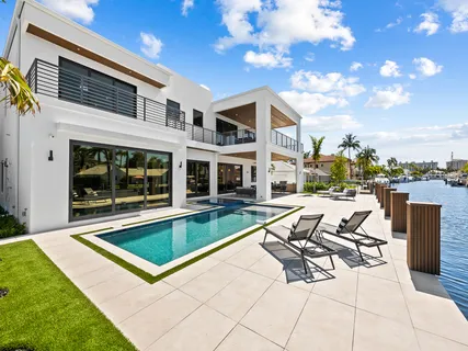 a view of house with a yard from a lake view