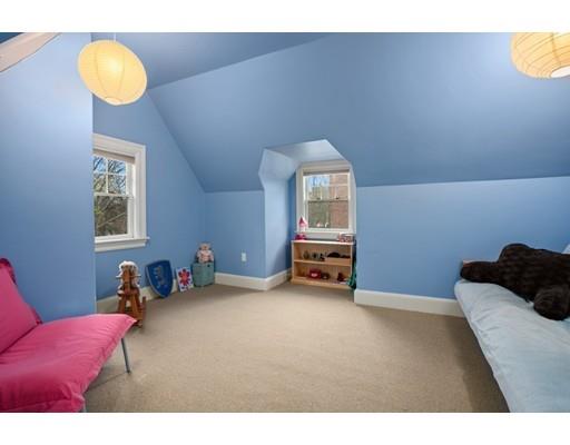 85 Griggs Road Brookline, MA 02446 - Photo 12 of 28 a bedroom with furniture and a chandelier