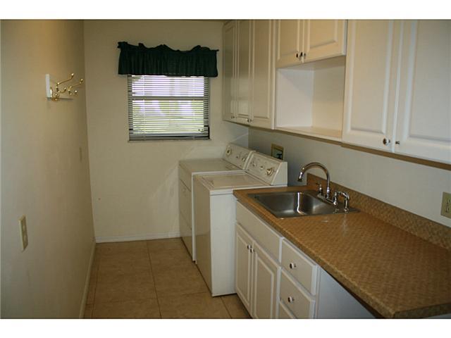 14 Knowles Road Stuart, FL 34996 - Photo 11 of 17 a kitchen with a sink and cabinets