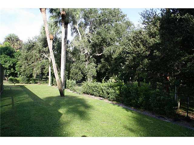14 Knowles Road Stuart, FL 34996 - Photo 7 of 17 a backyard of a house with a yard and outdoor seating