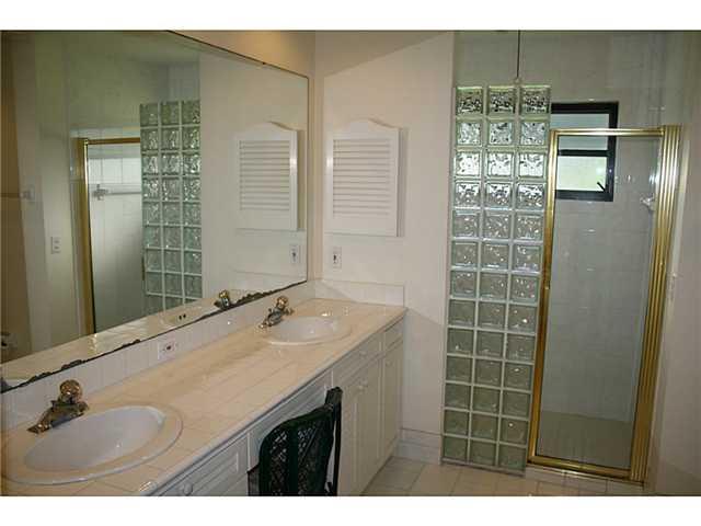 14 Knowles Road Stuart, FL 34996 - Photo 8 of 17 a bathroom with a granite countertop sink a shower and a mirror