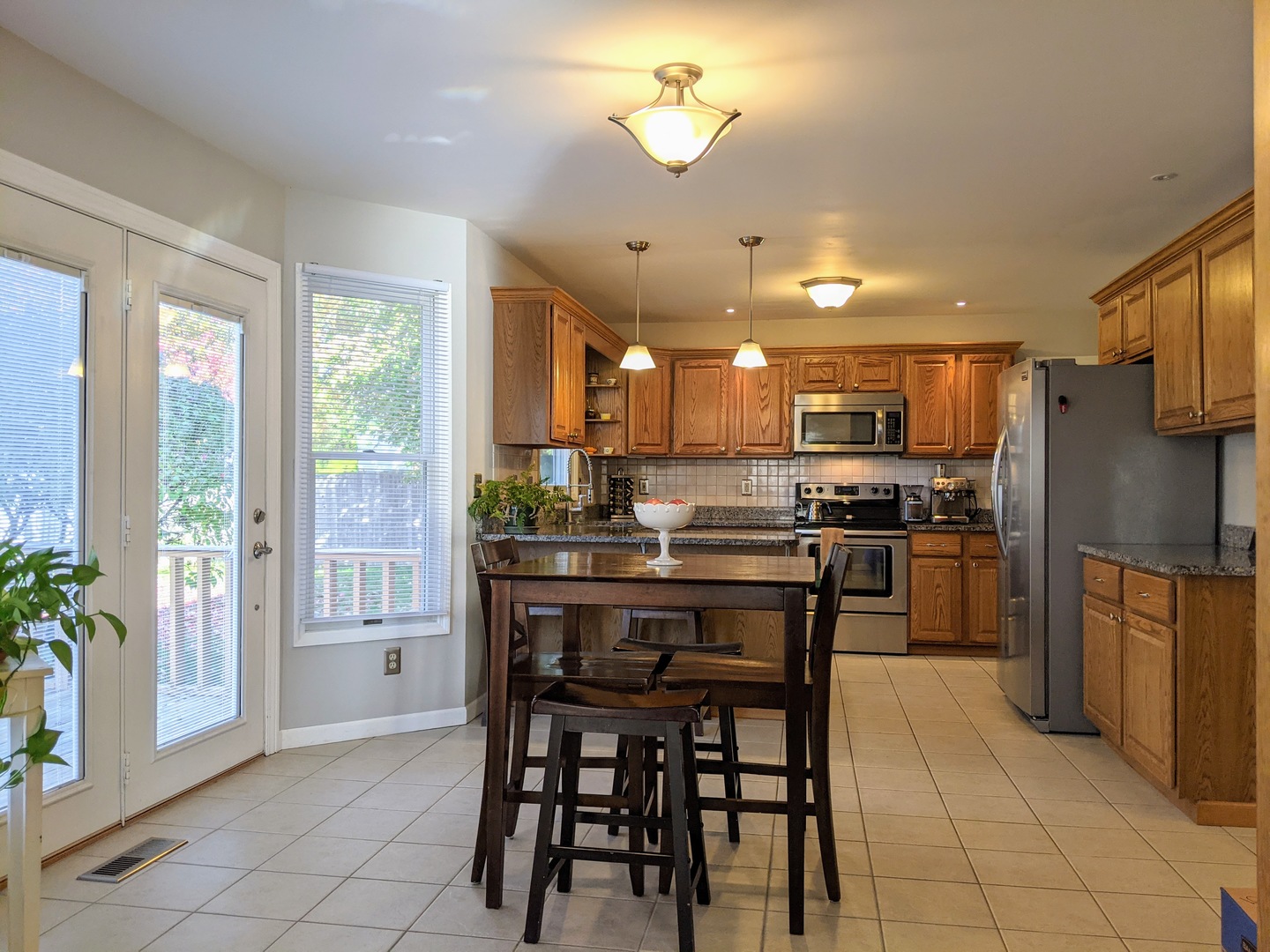 1409 Cobblefield Road Champaign, IL 61822 - Photo 15 of 73 a kitchen with a dining table chairs and refrigerator