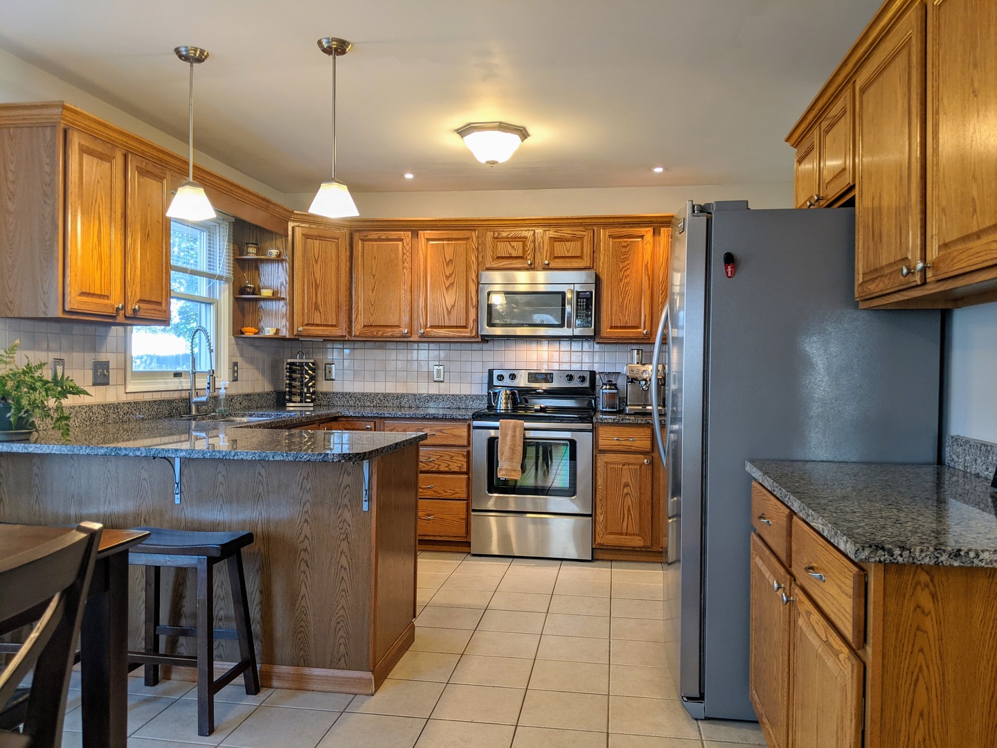 1409 Cobblefield Road Champaign, IL 61822 - Photo 27 of 73 a kitchen with stainless steel appliances granite countertop a sink a stove and a refrigerator