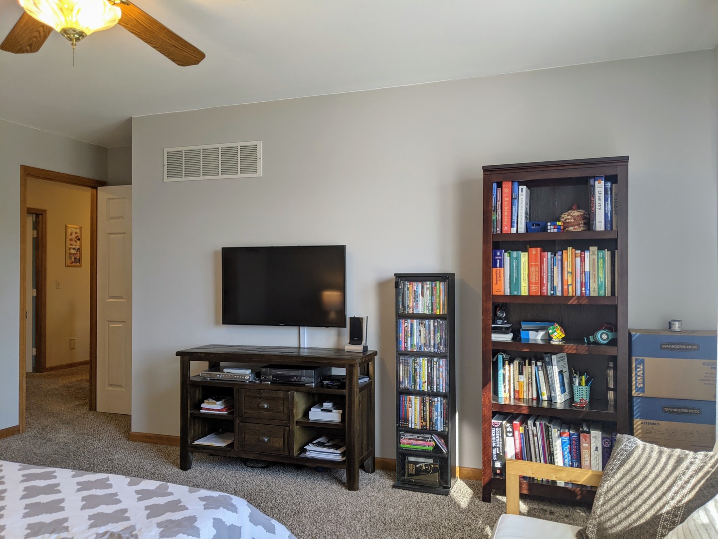 1409 Cobblefield Road Champaign, IL 61822 - Photo 38 of 73 a living room with bookshelf and a flat screen tv