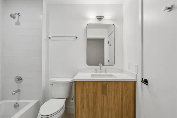 a kitchen with stainless steel appliances a refrigerator and a stove top oven