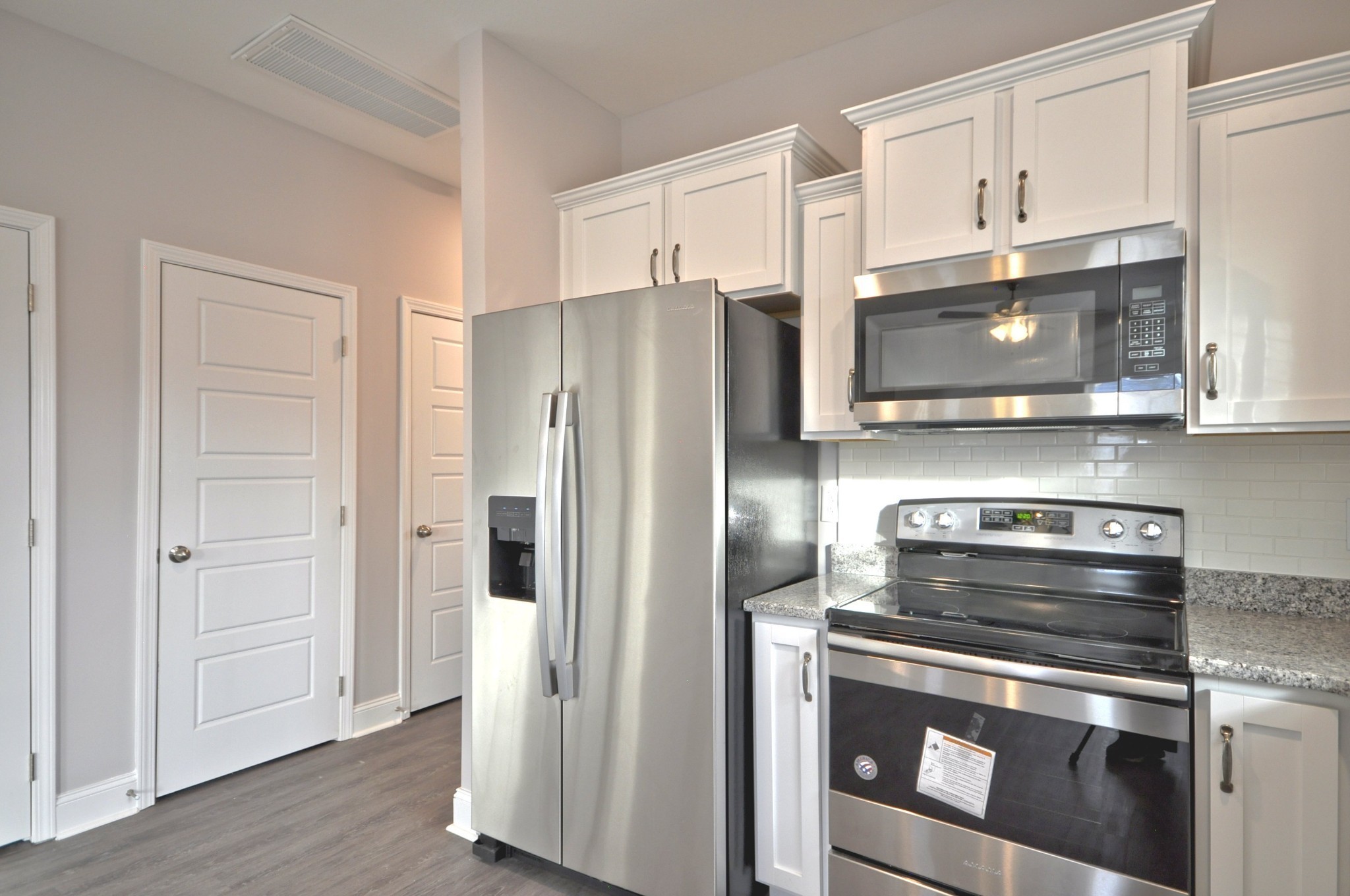 172 Bainbridge Drive, Unit B Clarksville, TN 37043 - Photo 15 of 35 a kitchen with stainless steel appliances a stove a microwave and cabinets