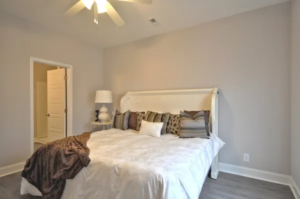 a bedroom with a bed and a night stand