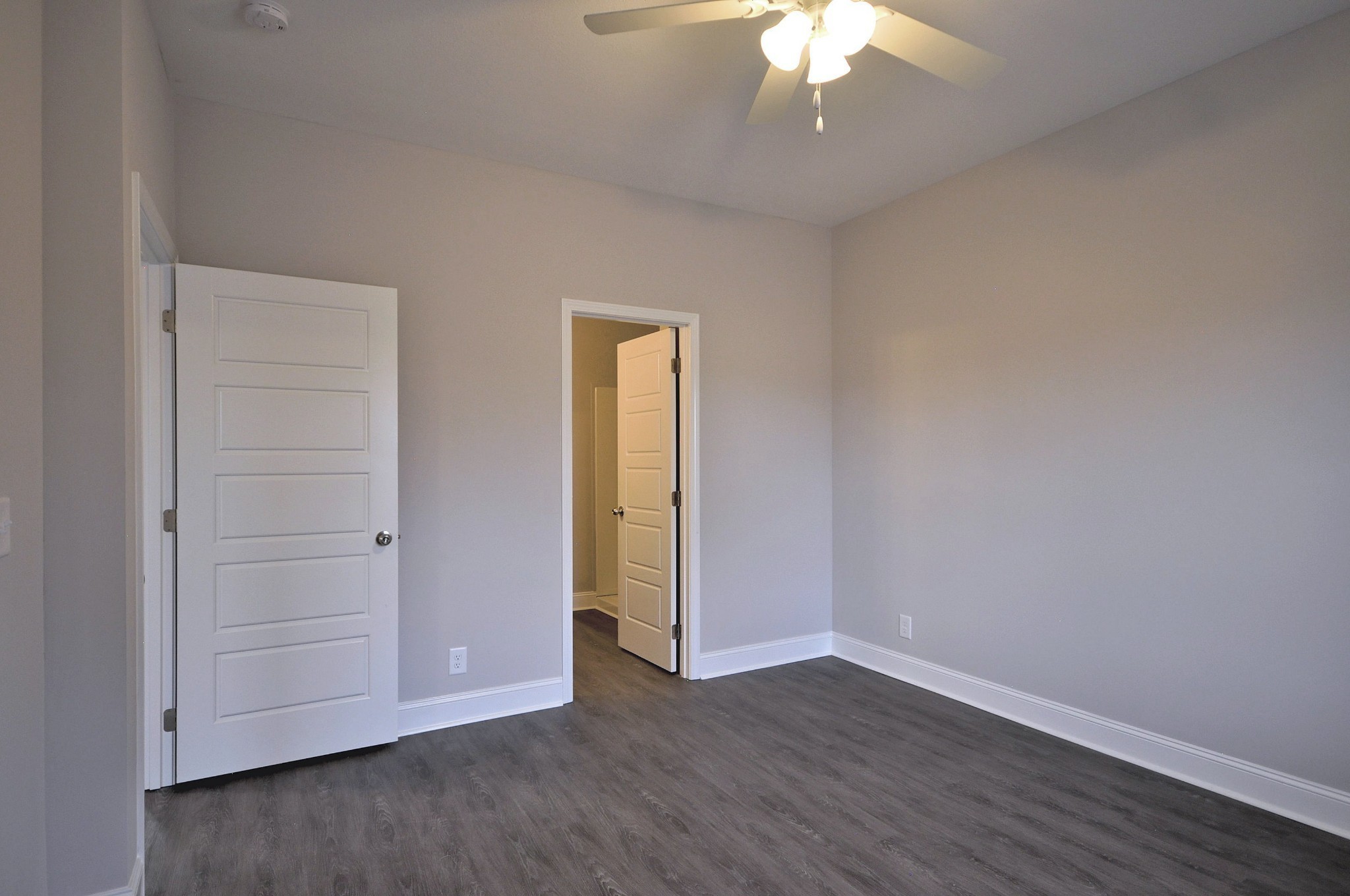 172 Bainbridge Drive, Unit B Clarksville, TN 37043 - Photo 25 of 35 an empty room with wooden floor chandelier fan and windows