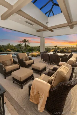a balcony with furniture and a large window