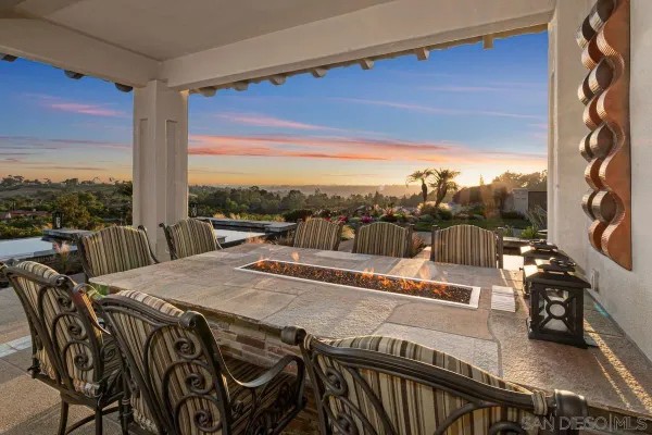 a view of a balcony dining table and chairs