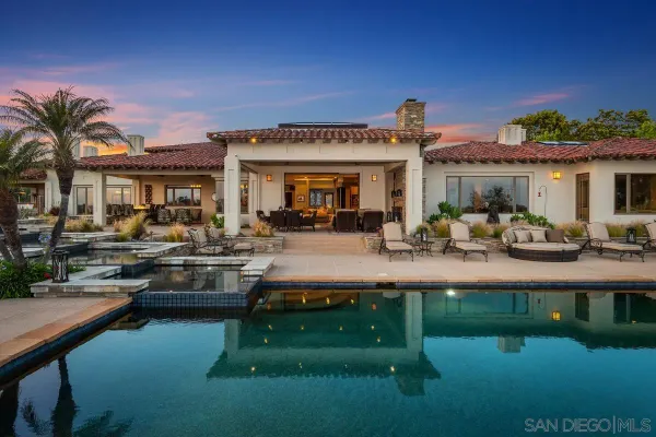 a swimming pool view with outdoor seating