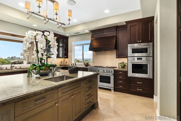 a kitchen with a sink stainless steel appliances and cabinets