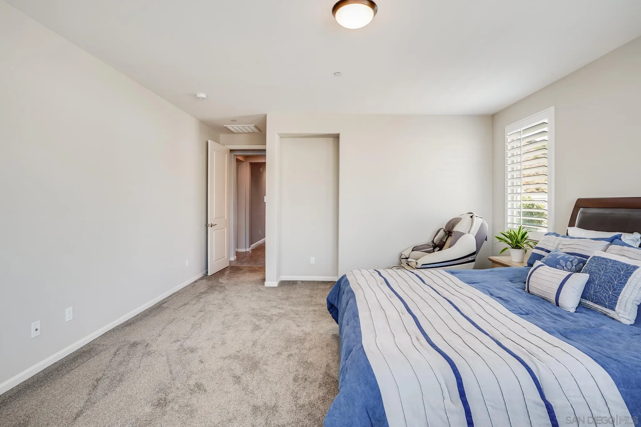 5662 Rancho Del Caballo Bonsall, CA 92003 - Photo 22 of 60 a bedroom with bed and a couch