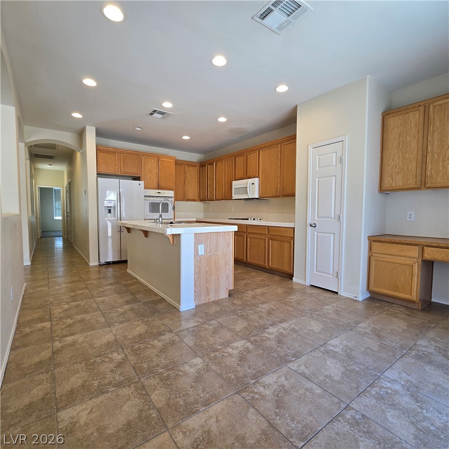 9234 Kingston Road Henderson, NV 89074 - Photo 14 of 38 An inviting kitchen with a central island and a full suite of appliances awaits your culinary touch.
