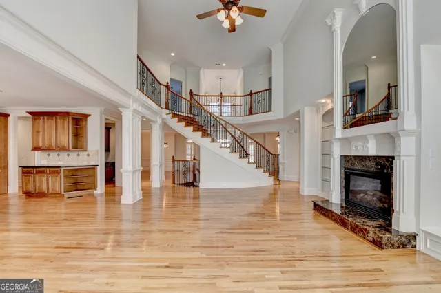 a kitchen with stainless steel appliances granite countertop a sink a stove and wooden floor