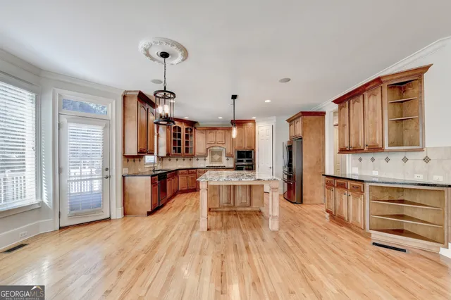 a kitchen with kitchen island granite countertop a stove and a granite counter tops