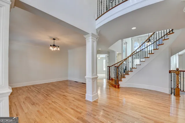 a view of empty room with wooden floor